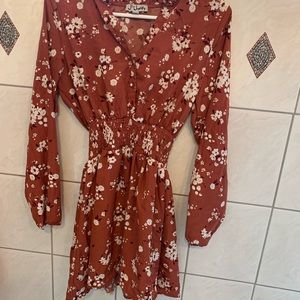 Rust/light red knee length dress with flower pattern. Never worn.
